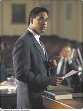 A photo shows a lawyer arguing a case in a courtroom.
