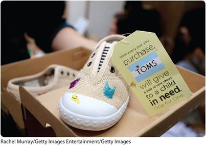 A photo shows a pair of children’s shoes, one inside the shoebox, and the other on the flap of the box.